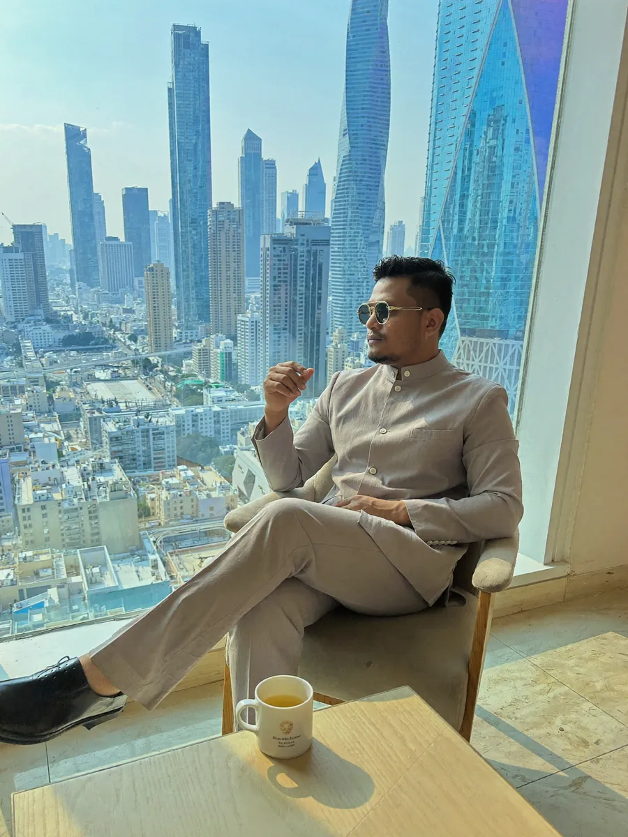 AI-generated image of Habib with a coffee by a city window